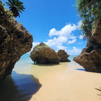 Hidden beach with limestone rocks and clear water in northern Ishigaki Island